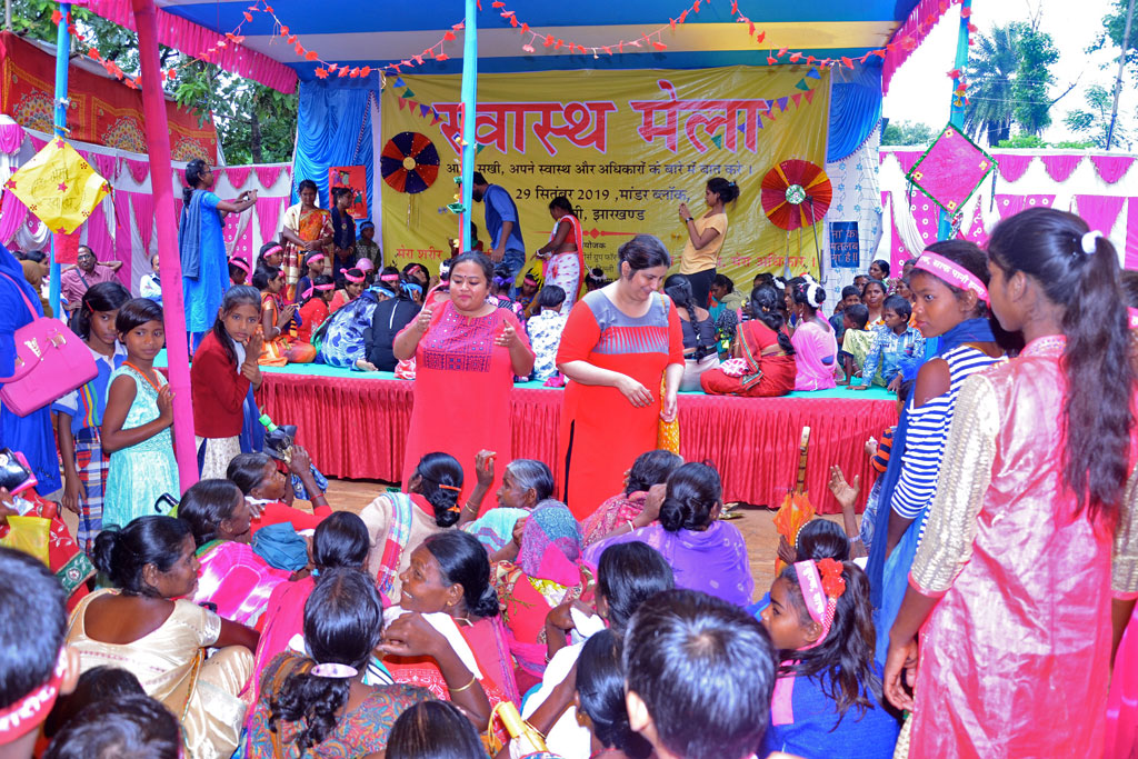 Engaging with women and girls with slogans during the Health Mela.