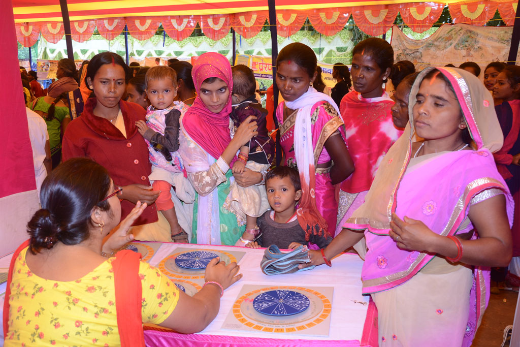 One of the stalls displaying Sama's Fertility Wheel, being explained to visiting women.